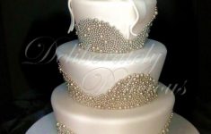 Wedding Cake Pearl Decorations 900 Applying Lots Of Pearls To Cake 58f0f47b68b03 wedding cake pearl decorations|guidedecor.com